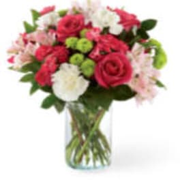 Pink and white mixed bouquet in a clear glass vase