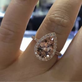 Pear-shaped pink gemstone ring on a finger