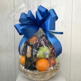 Gift basket of fruit wrapped in clear cellophane with a large blue bow