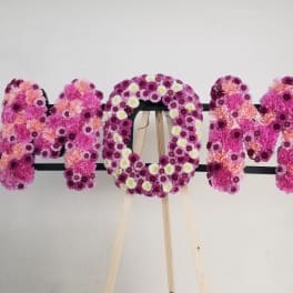 Floral letters spelling MOM in pink and purple flowers
