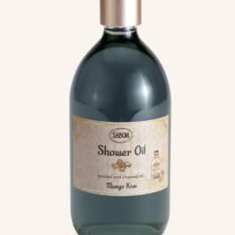 Bottle of shower oil with a gold cap and label
