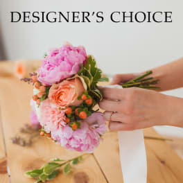 Pink and peach bridal bouquet with a white ribbon
