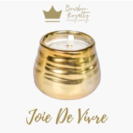 Gold candle in a rounded metallic holder with a white wick