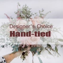 Hand-tied bouquet of pale pink roses and airy greenery
