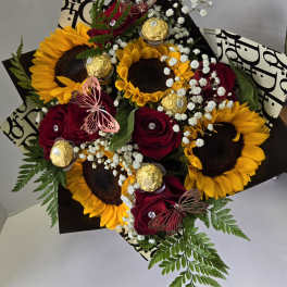 Bouquet of sunflowers and red roses with baby’s breath and chocolates