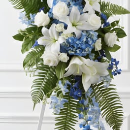 Tall blue and white floral standing spray on an easel
