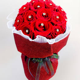 Red rose bouquet with rhinestone accents in glittery red wrap