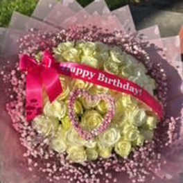 Pink and yellow rose bouquet with a birthday ribbon