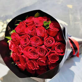 Bouquet of red roses wrapped in black and white paper