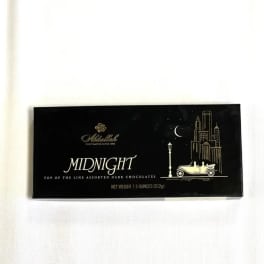 Box of assorted dark chocolates on a white surface