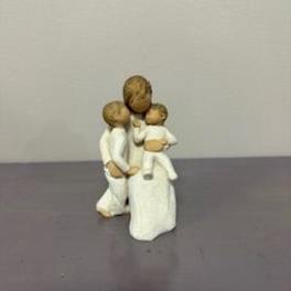 Small figurine of a woman holding two children
