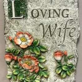 Decorative stone plaque reading "Loving Wife" with painted flowers