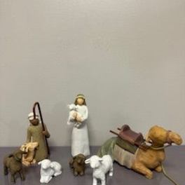 Small nativity figurines with a baby in a manger and two animals