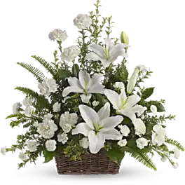 Basket arrangement of white lilies and white carnations