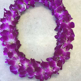 Purple orchid lei arranged in a circular garland