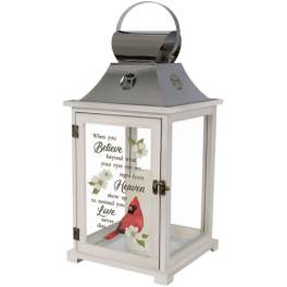 Decorative white lantern with a cardinal and memorial text on the glass