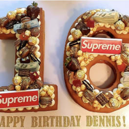 Number 18 birthday display decorated with candy and cash