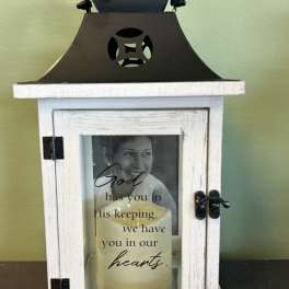 Decorative memorial lantern with a candle and photo inside