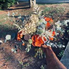 Orange rose bouquet with pale hydrangea and eucalyptus