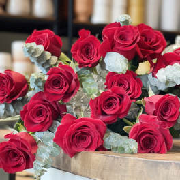 Bouquet of red roses with pale blue eucalyptus