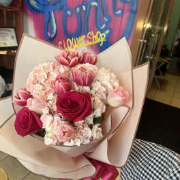 Pink and white bouquet with roses and tulips wrapped in blush paper