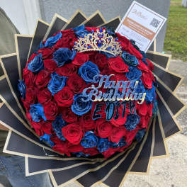 Red and blue rose bouquet with a jeweled crown and birthday topper