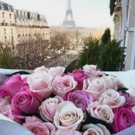 Bouquet of pink and pale roses with the Eiffel Tower in the background