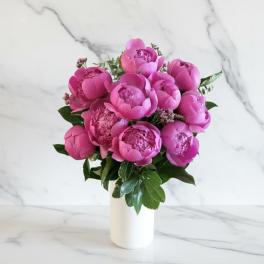 Pink peony bouquet in a white vase