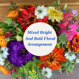 Mixed bright bouquet with colorful flowers and a center label