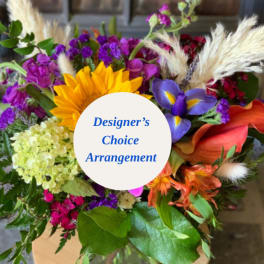 Colorful mixed bouquet with a sunflower, calla lilies, and purple blooms