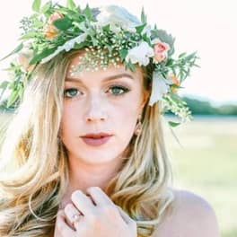 Woman wearing a floral crown with white and pink flowers