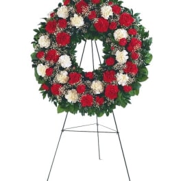 Red and white floral wreath on a standing easel