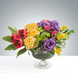 Colorful mixed bouquet in a glass pedestal bowl