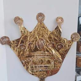 Gold crown-shaped foil balloon with confetti dots