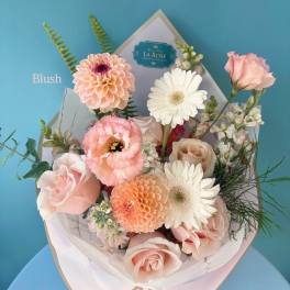 Pink and white mixed bouquet with roses, ranunculus, tulips, and carnations
