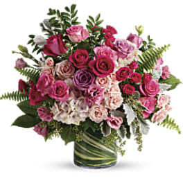 Pink and white rose bouquet in a glass vase