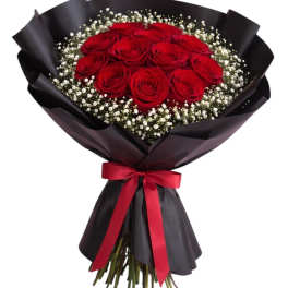 Bouquet of red roses with white baby's breath wrapped in black paper and a red ribbon