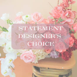 Pink and white floral arrangement with roses and orchids