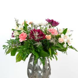 Mixed bouquet in a silver vase with pink, white, and purple flowers