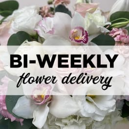 White and pink floral bouquet with orchids and roses