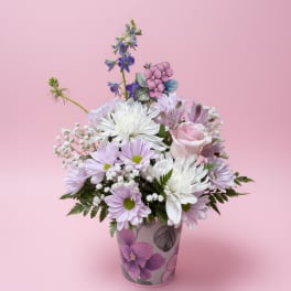 Pink and white mixed bouquet in a floral-patterned vase