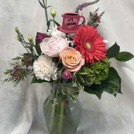 Mixed bouquet in a glass vase with a pink "#1 Mom" pick