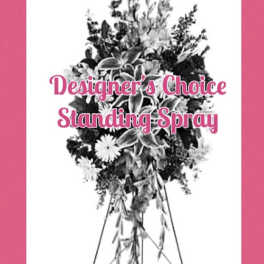 Standing spray on an easel with mixed flowers and greenery