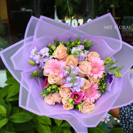 Lavender-wrapped bouquet of pink roses and gerbera daisies