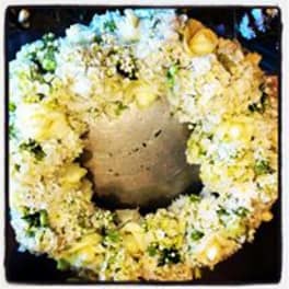 Yellow and white floral wreath around a central candle