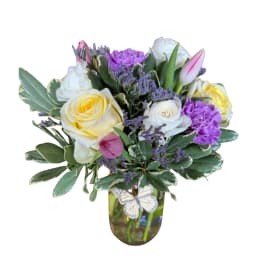 Bouquet of yellow and white roses in a glass vase