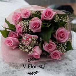 Pink rose bouquet wrapped in pale pink paper