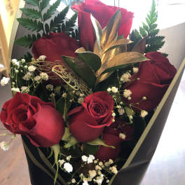 Bouquet of red roses with baby's breath in black wrap