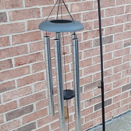 Blue ribbon wind chime with a small floral accent