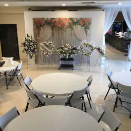 Wedding floral display with pink and white arrangements on stands
